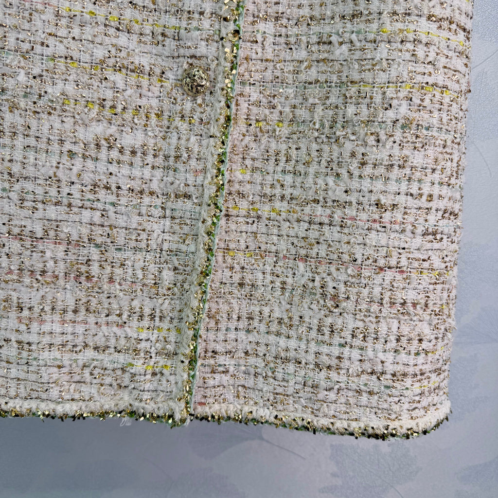 A light beige tweed blend short-sleeved jacket