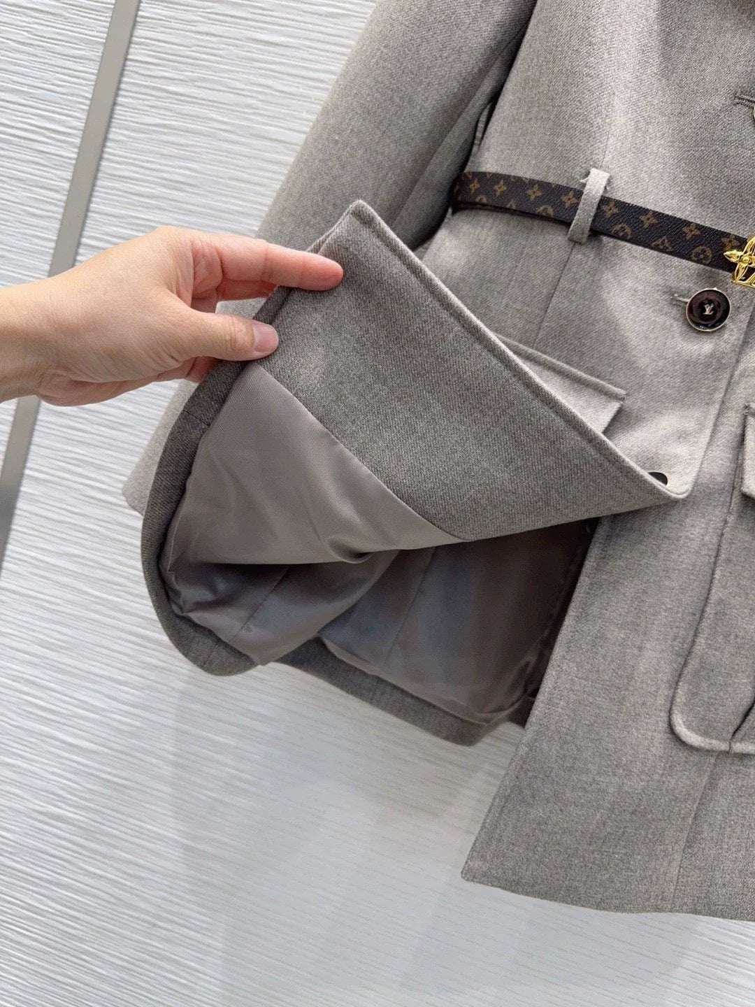 26Long-Sleeve Blazer with Contrast-Color Logo, Pockets, and Waist Belt